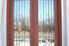 Architect: Nicholas Cusano. Bronze door grille.