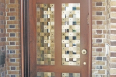 Architect: Ike & Kliggerman. Bronze door grille.