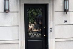 Architect: John Murray. Steel and bronze grille, bronze lighting, and bronze canopy.