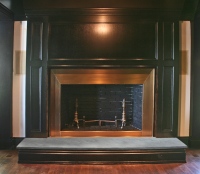 Design by Firedance Studio, LLC. Bronze fireplace surround.