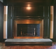 Design by Firedance Studio, LLC. Bronze fireplace surround.
