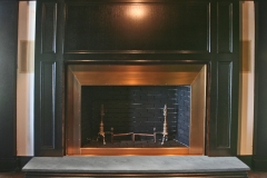 Design by Firedance Studio, LLC. Bronze fireplace surround.